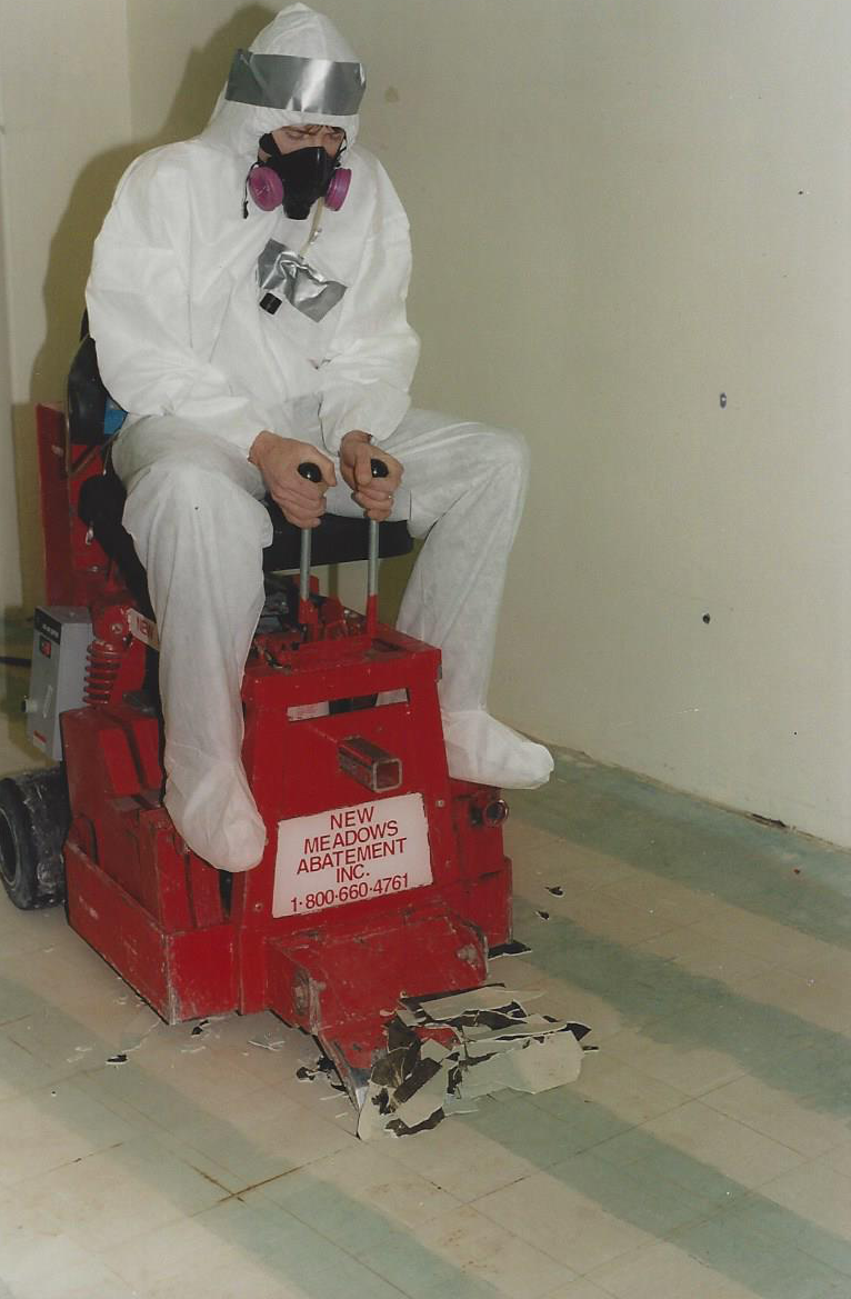 man using machine to remove asbestos flooring